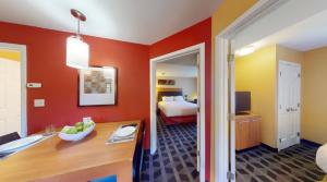 a room with a bedroom with a bed and a desk at Residences at Tewksbury in Tewksbury +18 photos