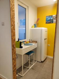 a kitchen with a sink and a refrigerator at Апартамент Pavlin in Plovdiv