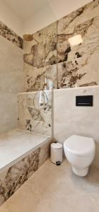 a bathroom with a toilet and a sink and a tub at Mystique Apartment in Opatija +52 photos