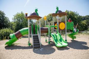 a playground with a slide and a slideintend at Camping Paradis Les Chanterelles in Saint-Rémy-sur-Durolle +18 photos