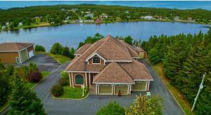 an aerial view of a house on a lake at Riverside Pool Chalet ! in Clarkes Beach