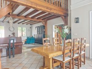 a dining room with a wooden table and a piano at Maison familiale in Rueil-Malmaison