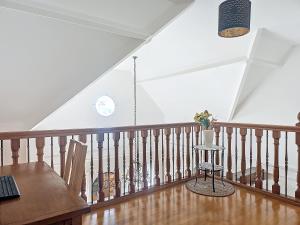 a room with a staircase with a table and a chair at Maison familiale in Rueil-Malmaison