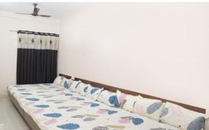 a bed with pillows on it in a room at Vidya home stay- 500 mt from Mahakal lok and railway station in Ujjain