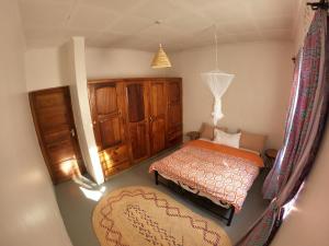 a bedroom with two beds and a chair in it at Nomads nest safari house in Arusha +10 photos