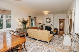 a living room with a couch and a table at Badgemore Cottage in Henley on Thames