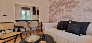a living room with a white couch and a table at Mystique Apartment in Opatija