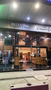 a store front with a reflection of a building at Al Thanaa Alraqi Furnished Apartments in Jeddah +31 photos