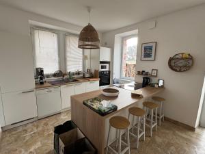 a kitchen with a island with bar stools at Villa Ker Jean in Brignogan-Plage