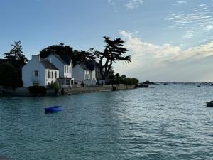 a house on the shore of a body of water at Villa Ker Jean in Brignogan-Plage