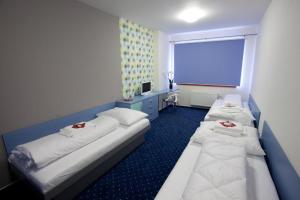 Posteľ alebo postele v izbe v ubytovaní Hotel Galaxie