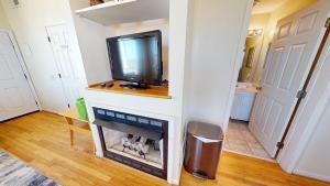 a living room with a flat screen tv on a wall at Little Peace of Heaven in Folly Beach