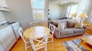 a living room with a couch and a table at Little Peace of Heaven in Folly Beach +23 photos