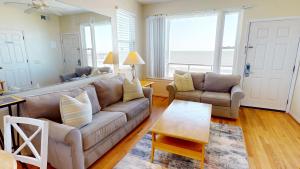 a living room with a couch and a table at Little Peace of Heaven in Folly Beach