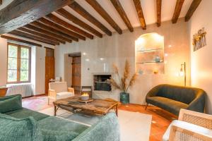 a living room with two couches and a table at Moulin Bondon, group cottage - 14 beds in Graçay