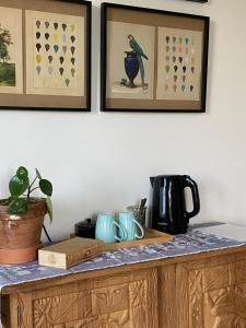 a counter with two framed pictures and a bird on the wall at La Maison de l'Andelot in Monteignet-sur-lʼAndelot +30 photos