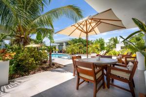 The swimming pool at or close to White Villas - Romantic Getaway - Oceanside Large Modern Studio with Pool, 500ft from Long Bay Beach