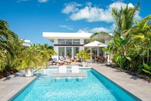 The swimming pool at or close to White Villas - Romantic Getaway - Oceanside Large Modern Studio with Pool, 500ft from Long Bay Beach