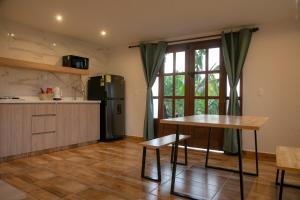 a kitchen with a table and a refrigerator at Loft para grupos parqueadero gratis LIRIO in Jardin