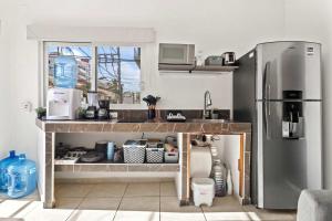 a kitchen with a stainless steel refrigerator and a counter at Madison - 99 Steps to Beach in Golden Zone in Bucerías +11 photos