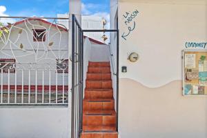 a stairway leading up to a building with a gate at Madison - 99 Steps to Beach in Golden Zone in Bucerías +11 photos