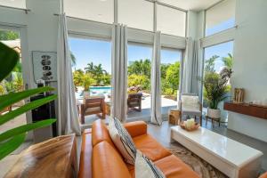 A balcony or terrace at White Villas - Romantic Getaway - Oceanside Large Modern Studio with Pool, 500ft from Long Bay Beach