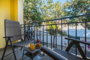a balcony with two chairs and a plate of food at Old Town Charm Apartment in Albufeira