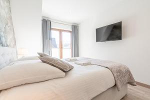 Posteľ alebo postele v izbe v ubytovaní Gąsienica Apartamenty Queen