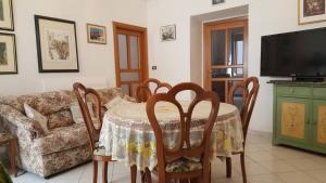 a living room with a table and a couch at Casa la Torre - YourPlace Abruzzo in Rocca San Giovanni