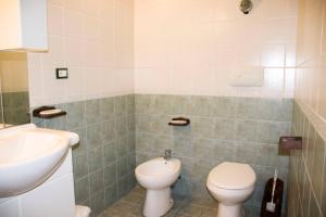 a bathroom with a toilet and a sink at Casa la Torre - YourPlace Abruzzo in Rocca San Giovanni +10 photos