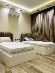 1 dormitorio con 2 camas y aire acondicionado en Luxurious Lake View Flat 2BR 115, en New cairo