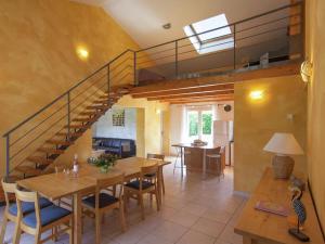 a living room with a table and a staircase at Villa Cethi in Boissières