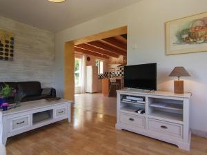 a living room with a television on a white entertainment center at Villa Cethi in Boissières