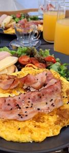 a table with a plate of food with meat and vegetables at White Cave Villas in Oia