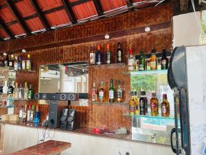 a bar with a lot of bottles on the wall at Richita resort in Calangute