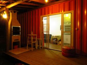 a room with red walls and a sliding glass door at Ekontainer Hospedaria Praia Do Rosa in Praia do Rosa