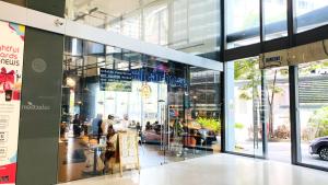 a store front of a building with people in it at Summer Suites by Western Holiday in Kuala Lumpur