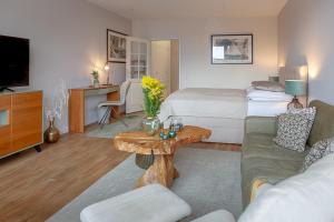 a hotel room with a bed and a living room at F35B 18 Seaside 18 in Westerland (Sylt)