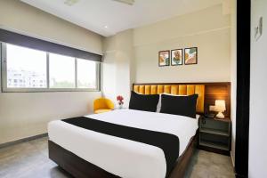 a bedroom with a large bed and a window at Hotel O Siba Inn in Mumbai