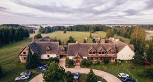 an aerial view of a large house with cars parked at Zagroda Kuwasy in Woźnawieś