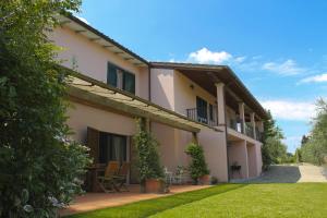 an exterior view of a house with a yard at Tuscany Roses in Arezzo