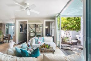 a living room with a couch and a ceiling fan at Zen Villa in Key West