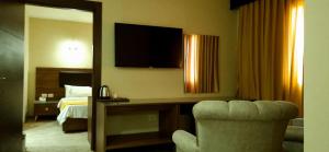 a hotel room with a bed and a desk with a chair at al sultanhotel downtown in Tripoli