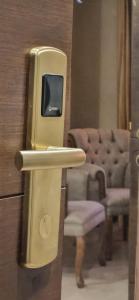 an old tv on a door in a room with a chair at al sultanhotel downtown in Tripoli