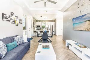 a living room with a couch and a table at Romantic Escape, Walk to Beach, Pool, Hammock in Long Bay Hills