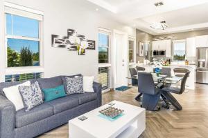 a living room with a couch and a table at Romantic Escape, Walk to Beach, Pool, Hammock in Long Bay Hills