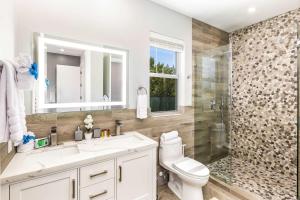a bathroom with a toilet and a sink and a shower at Romantic Escape, Walk to Beach, Pool, Hammock in Long Bay Hills