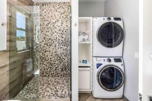 a laundry room with a washer and dryer at Romantic Escape, Walk to Beach, Pool, Hammock in Long Bay Hills