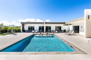 a swimming pool in the backyard of a house at Romantic Escape, Walk to Beach, Pool, Hammock in Long Bay Hills