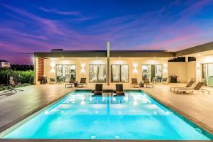 a swimming pool in the middle of a house at Romantic Escape, Walk to Beach, Pool, Hammock in Long Bay Hills